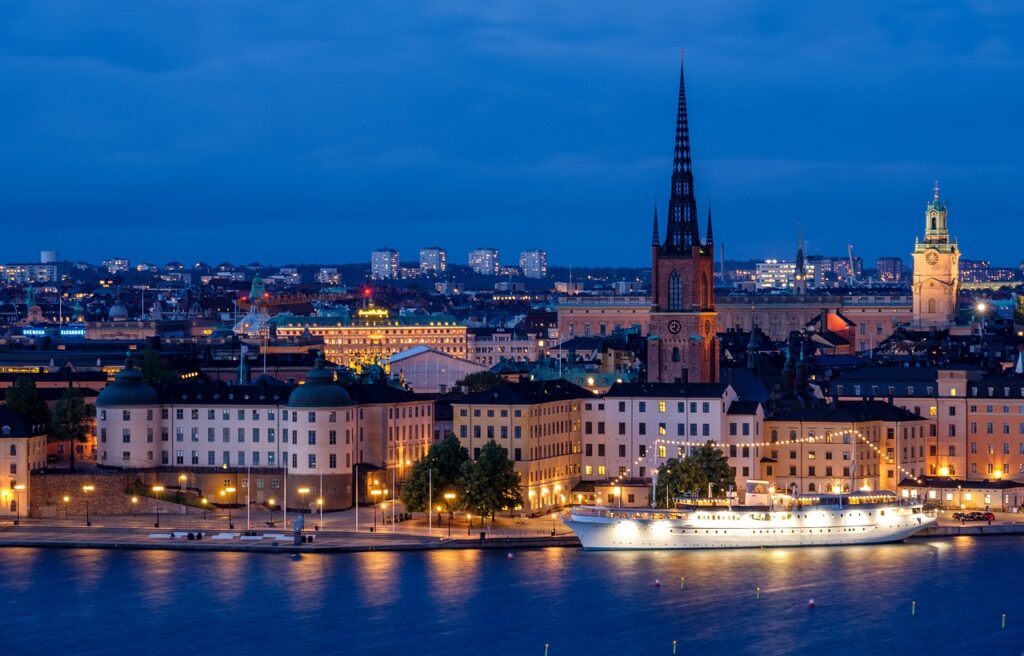city, cityscape, waterfront, illuminated, ship, architecture, skyline, historic center, church, steeple, water, sea, night, nature, evening, twilight, lights, mirroring, stockholm, sweden, scandinavia